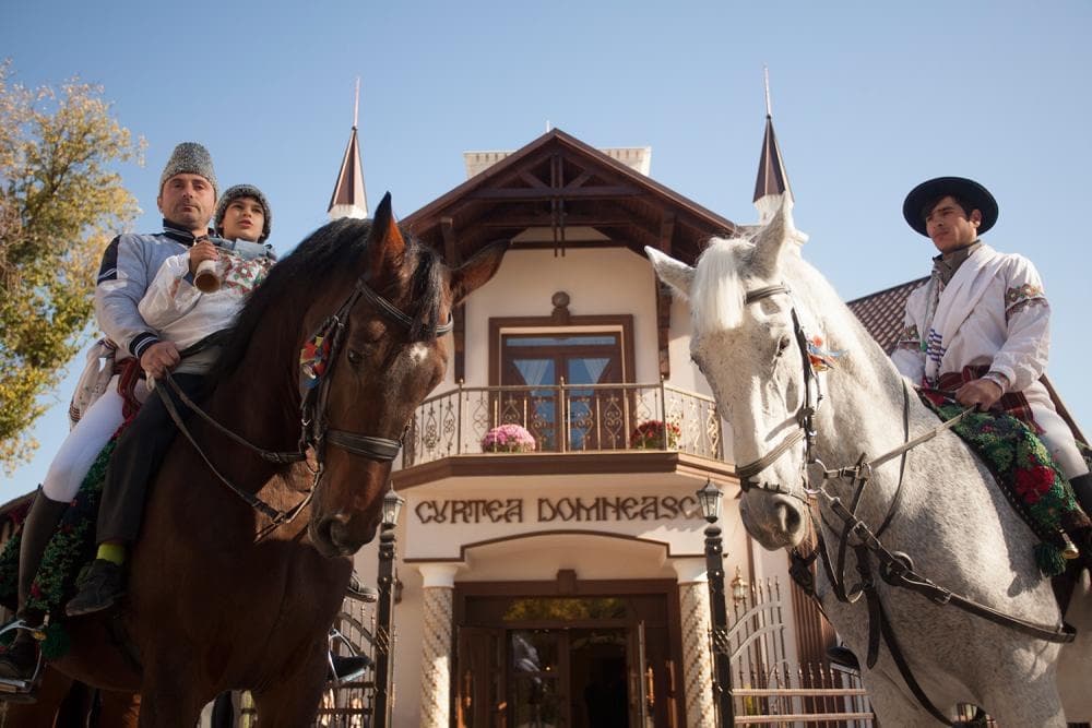 Riders in traditional costume in front of the Curtea Domnească building, Cricova